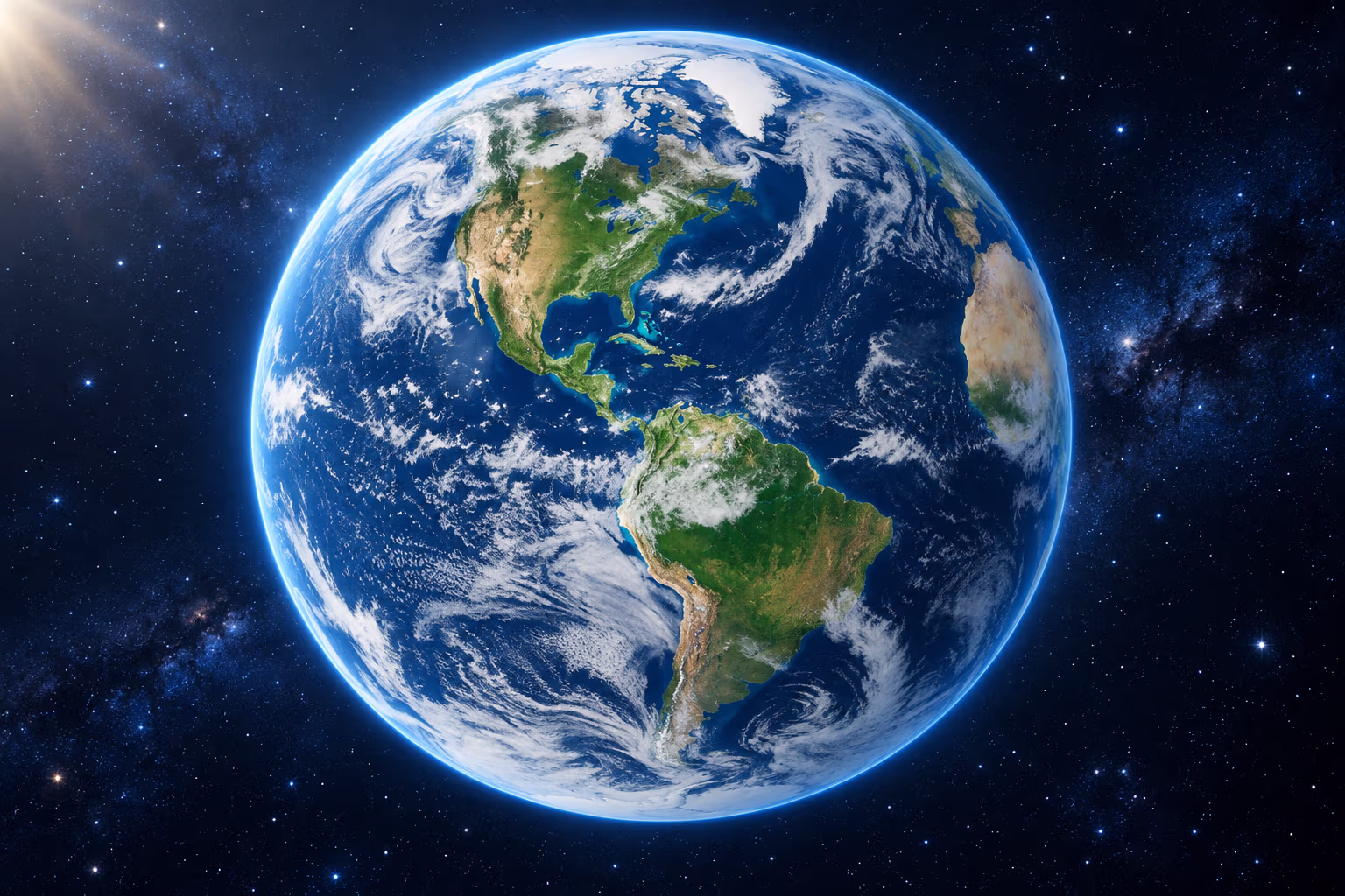 A blue and green Earth with white clouds seen from orbit against deep blue space.
